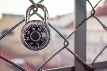 closed numeric padlock on a metal gate as a symbol of an unknown love in Lisbon.