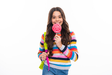 Teenager girl with caramel candies on sticks, sweet sugar addiction. Child with lollipops. Happy girl face, positive and smiling emotions.