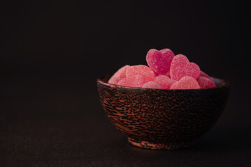 Red jelly heart shaped candy on black background.Concept for Valentine's day.