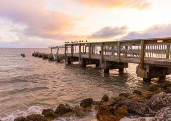 Naklejka na ściany i meble Sunset on Hurricane Damaged Pier on Casa Marina Beach, Key West Florida, USA