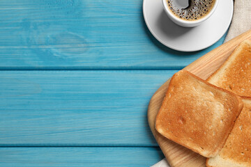 Slices of tasty toasted bread and aromatic coffee on turquoise wooden table, flat lay. Space for text
