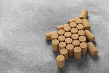 Christmas tree made of wine corks on grey table. Space for text