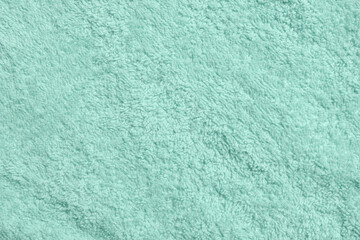 Obraz premium Soft light turquoise towel as background, top view