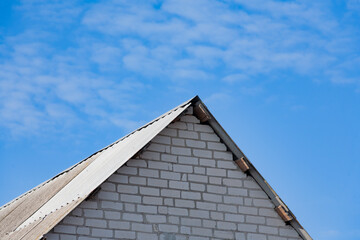 Roof of the world. The roof of a rural house close-up against the blue sky. Roof close-up. Low angle view.