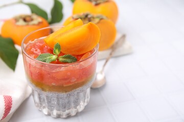 Delicious dessert with persimmon and chia seeds on table. Space for text