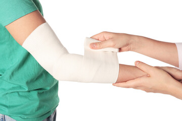 Doctor applying bandage onto patient's arm on white background, closeup