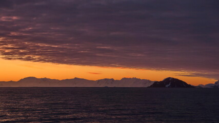 Sunset over the silhouette of mountains at Cierva Cove, Antarctica