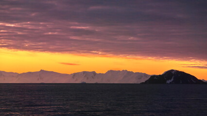Sunset over the silhouette of mountains at Cierva Cove, Antarctica