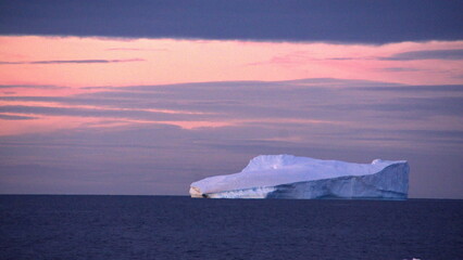 Iceberg floating in the Southern Ocean at sunset at Cierva Cove, Antarctica © Angela