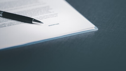 A pen and a contract on the table,Managing business documents and agreements Signing business contracts, approvals, confirmation of contract documents or warranty certificates.