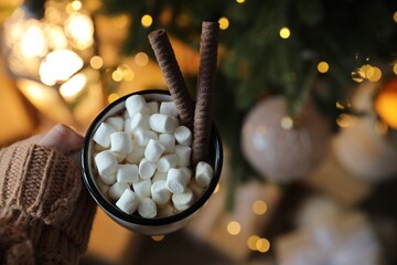 Woman with cup of cocoa indoors, top view. Christmas mood