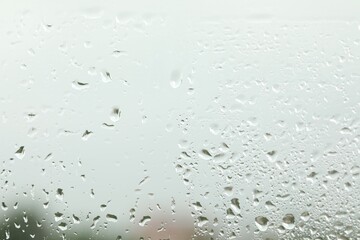 Window glass with raindrops as background, closeup