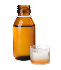 Bottle with measuring cup of syrup on white background. Cough and cold medicine