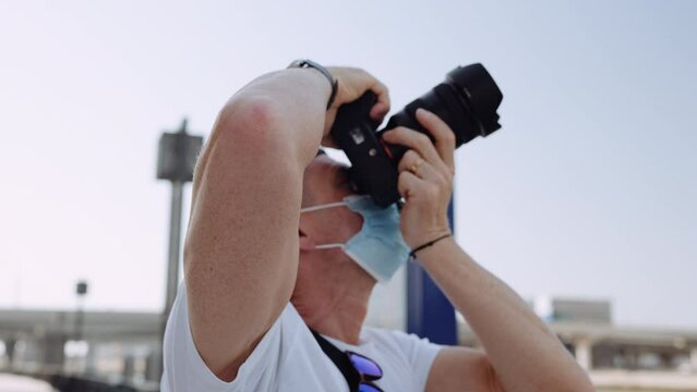 Close-up Shot Of A Photographer Taking Pictures At A Low Angle