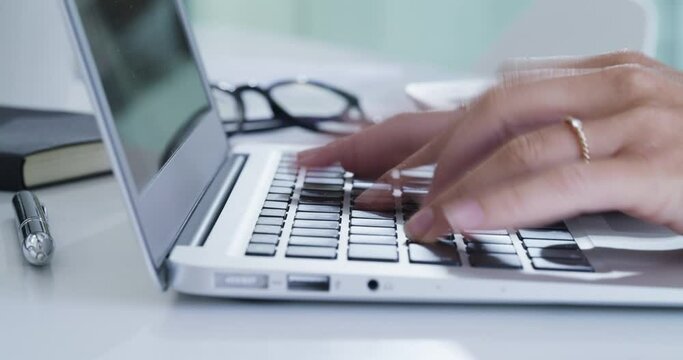 Business woman, hands typing and laptop with fast, busy and email at desk, online report and proposal with speed at work. Employee hand, technology and pc keyboard while internet search or networking