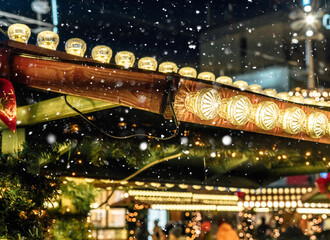 Lanterns with garlands at night. Traditional Christmas market decorations in the city. New Year celebration, holidays.	