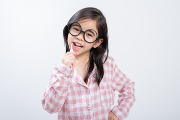 little girl Asia brushing teeth happily white background