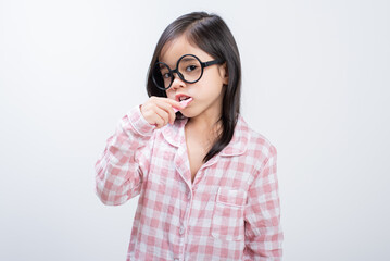 little girl Asia brushing teeth happily white background