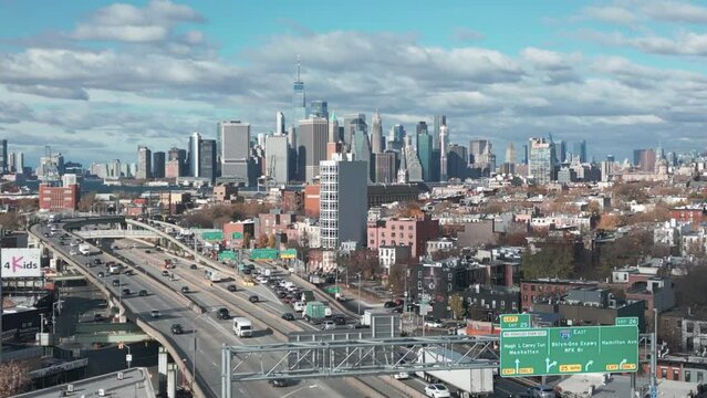 view of NYC skyline descending nexts to elevated Brooklyn Queens Expressway