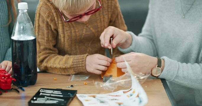 Toy building, mother and child in a home working together for science and children learning. Student school model help with a mom and kid build a education, engineering and creative project