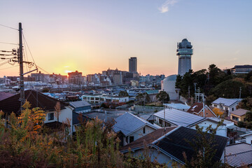 Landmark tower over houses in sprawling Akashi neighborhood at sunset