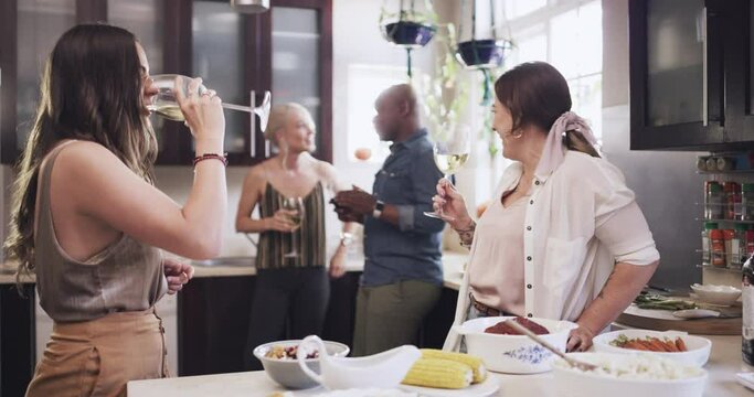 Wine, toast and friends in a kitchen for party, celebration or social gathering, relax and talking in a home. Champagne, cheers and group get together for christmas, festive and season event in house
