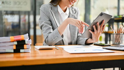 cropped shot, Beautiful asian businesswoman or female boss using tablet at her desk.