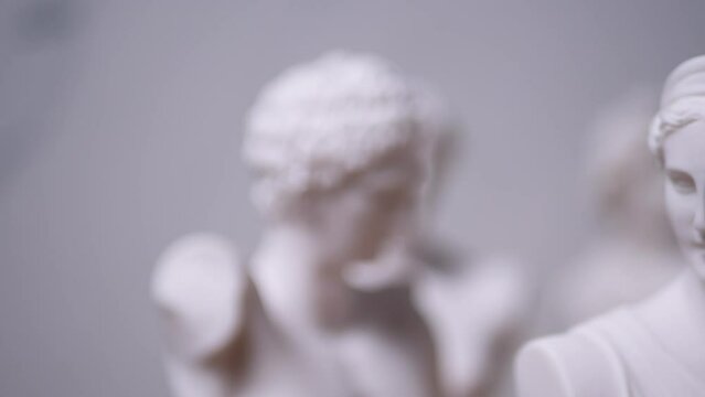 Statue of Greek Goddess Artemis with others out of focus - Left to Right