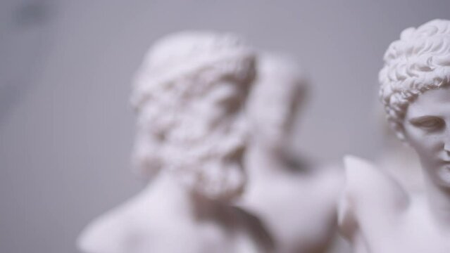 Statue of Greek God Apollo with others out of focus - Left to Right