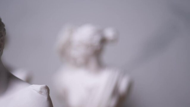 Statue of Greek God Apollo with others out of focus - Right to Left