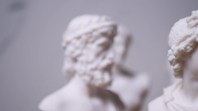 Statue of Greek God Hermes with others out of focus - Left to Right