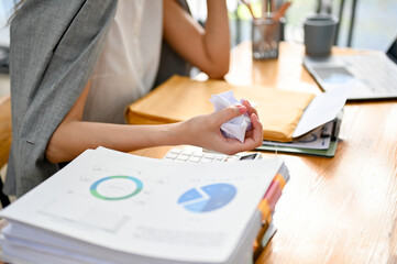 close-up image, A stressed and furious businesswoman with crumpled paper in her hand