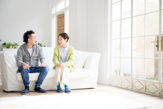 Image of an Asian couple smiling and talking amicably