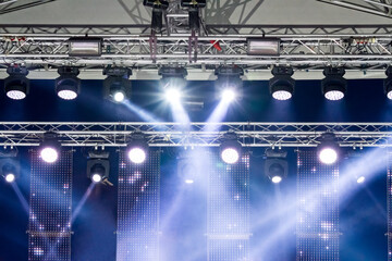stage lighting equipment. spotlights on outdoor concert stage with light beams.