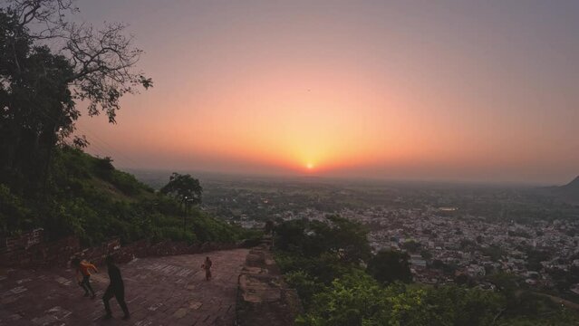 Sunrise time lapse with people moving on a Indian fort at Narwar fort, Shivpuri, Madhya Pradesh