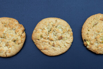 Pistachio and almond cookies on dark background.