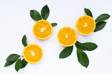 Orange fruit with green leaves on white background.