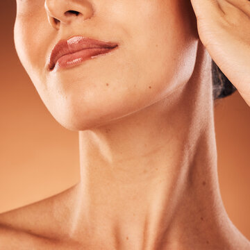 Lips, zoom and woman in a studio with beauty cosmetics, lipstick makeup or dermatology skincare products. Lip gloss, mouth and healthy model with clean or glowing face after self care or self love