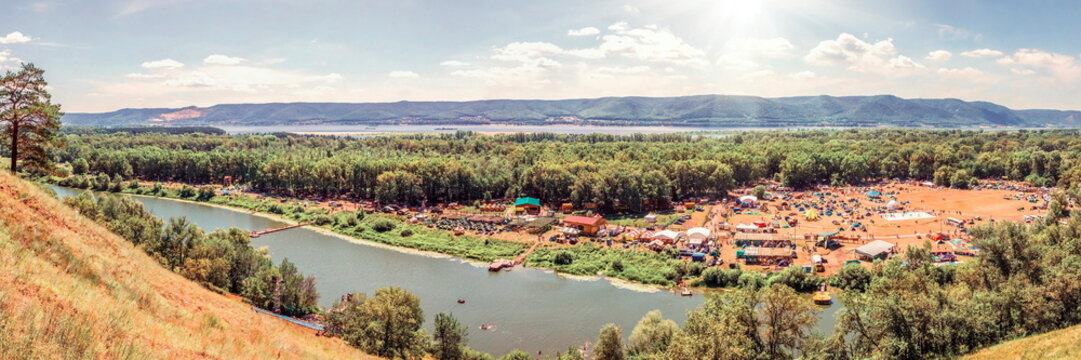 View from the left bank of the Volga River to the Zhiguli Mountains and to the glade of the Grushinsky Festival.
