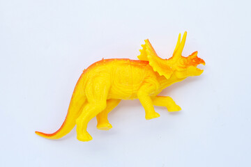 Plastic dinosaur toy on white background. Top view