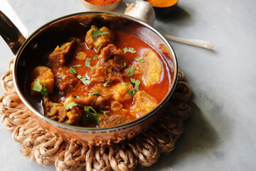Mutton Rogan josh or mutton masala is India's famous Spicy nonvegetarian dish. It's made out of Goat meat and spices, garnished with fresh coriander. Lamb curry. copy space.