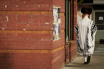 hasidic jewish man walks down the street in brooklyn
