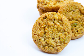 Pistachio and almond cookies on white background.