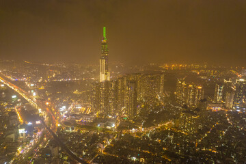 Fototapeta premium aerial view of Ho Chi Minh City in the morning, Top view aerial photo from flying drone of a Ho Chi Minh City with development buildings, transportation, energy power infrastructure.