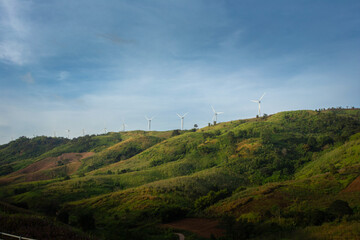 Group of windmills for renewable electric energy production. Wind turbines farm on mountains in rural areas. The clean energy system in Khao Kho District, Phetchabun, Thailand, Southeast Asia.