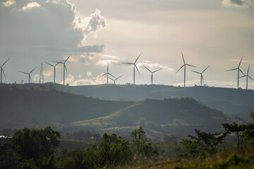 Group of windmills for renewable electric energy production. Wind turbines farm on mountains in...