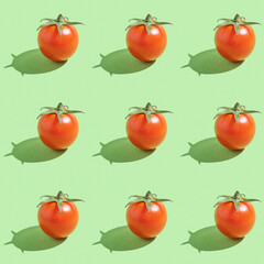 Seamless pattern with fresh cherry tomato on green background.