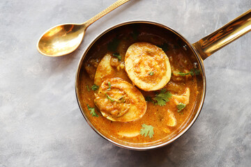 Egg Curry or Anda masala gravy, baida curry. Indian spicy food. Indian nonvegetarian Homemade food. Perfect Indian lunch. over moody background with copy space.
