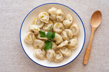 Plate with dumplings on cotton fabric background.