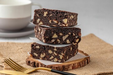 Chocolate brownies with peanut on a wooden board